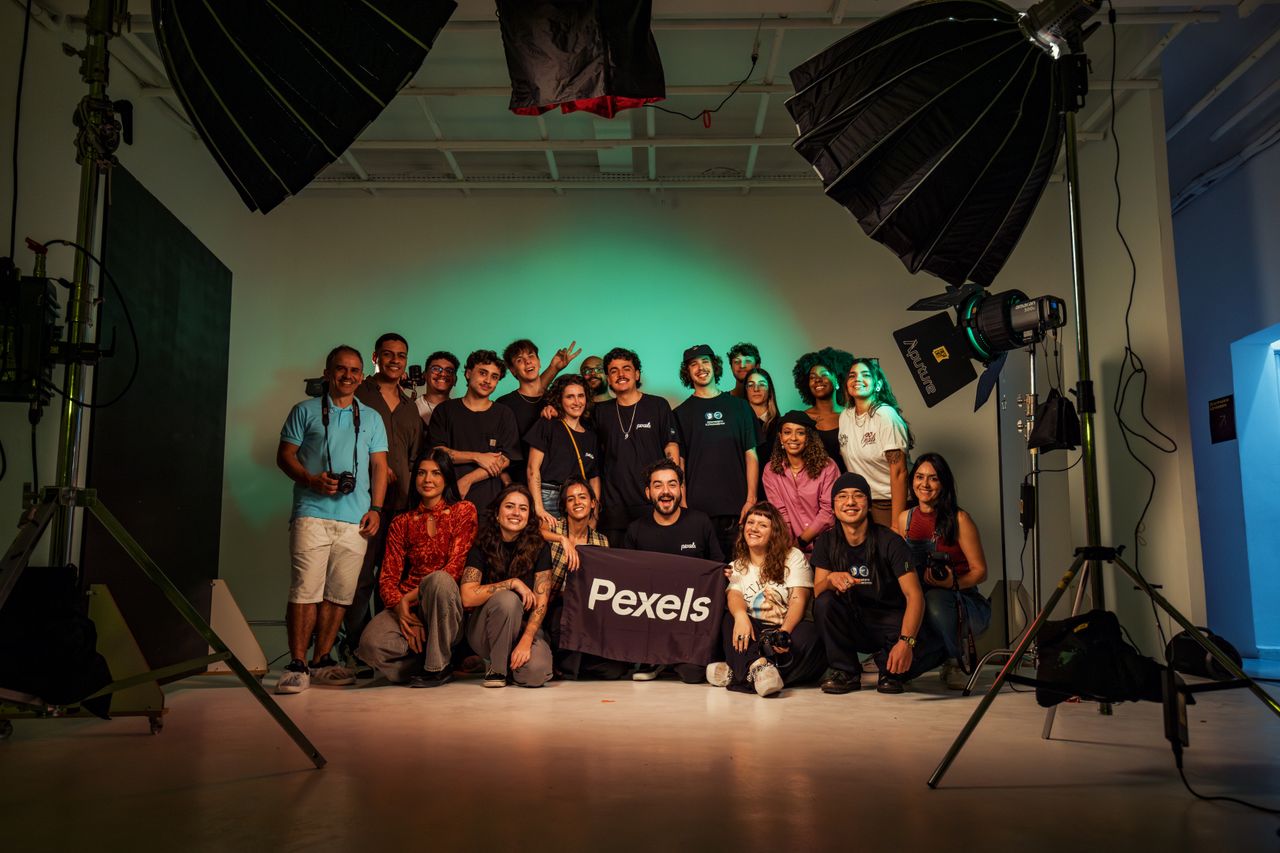 services-03 A diverse group of adults posing in a professional photography studio.