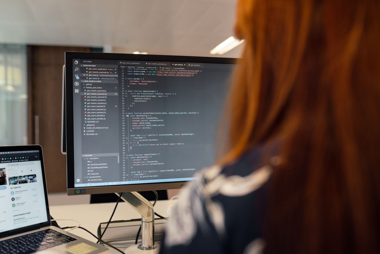 why-choose-us A female engineer works on code in a contemporary office setting, showcasing software development.